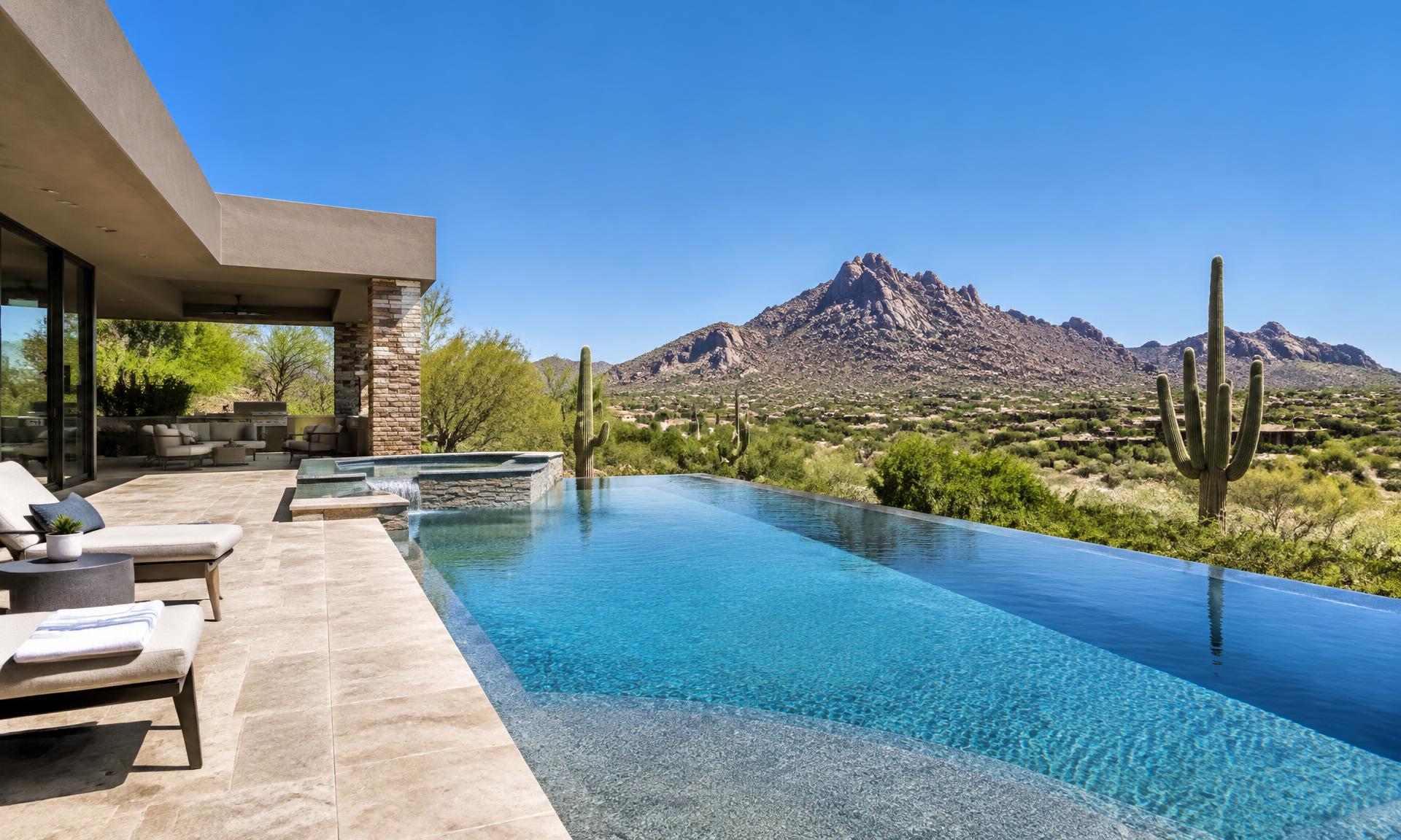 A desert modern Scottsdale home with an infinity-edge pool under a bright midday sky